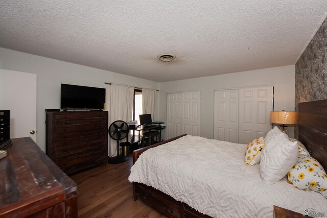 660 E 26th St, Yuma, AZ 85365 - bedroom featuring wood finished floors, multiple closets, and a textured ceiling