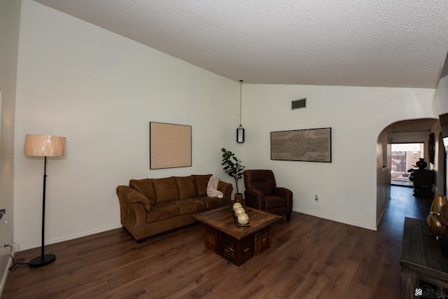 660 E 26th St, Yuma, AZ 85365 - living area with vaulted ceiling, arched walkways, dark wood finished floors, baseboards, and a textured ceiling