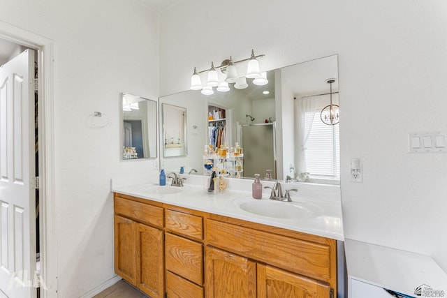 full bathroom featuring double vanity, a shower stall, and a sink