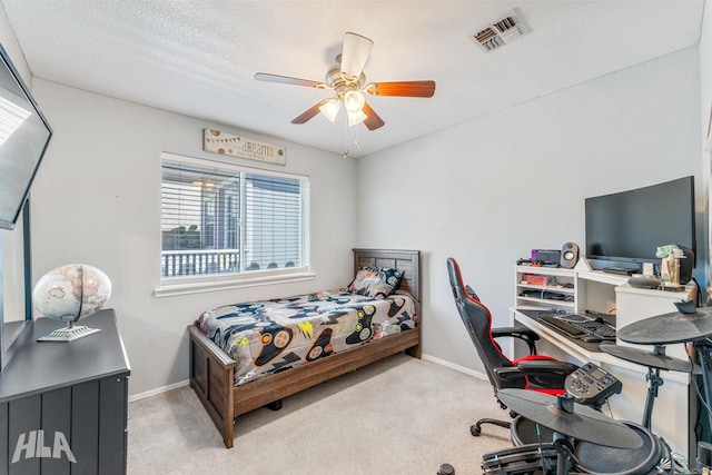 carpeted bedroom with baseboards, visible vents, and ceiling fan
