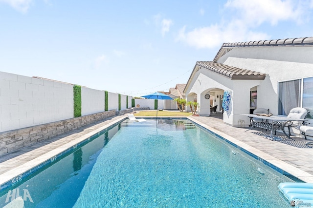 view of pool with a patio, a fenced in pool, and a fenced backyard