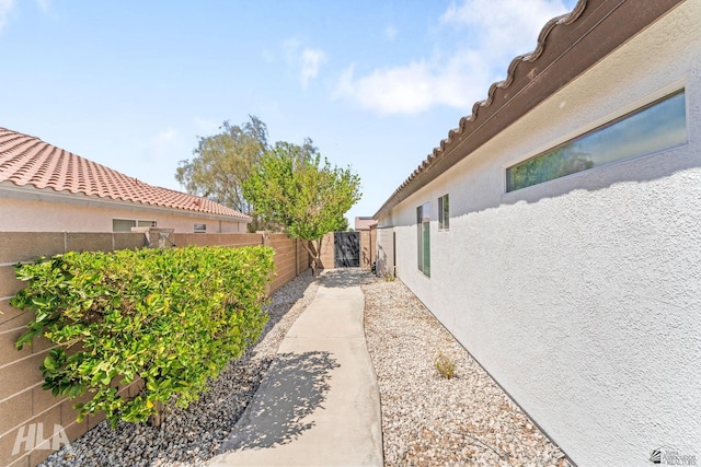 view of property exterior with a fenced backyard and stucco siding