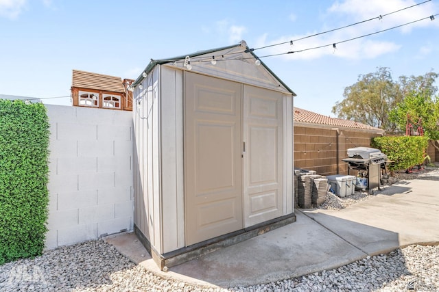 view of shed with a fenced backyard