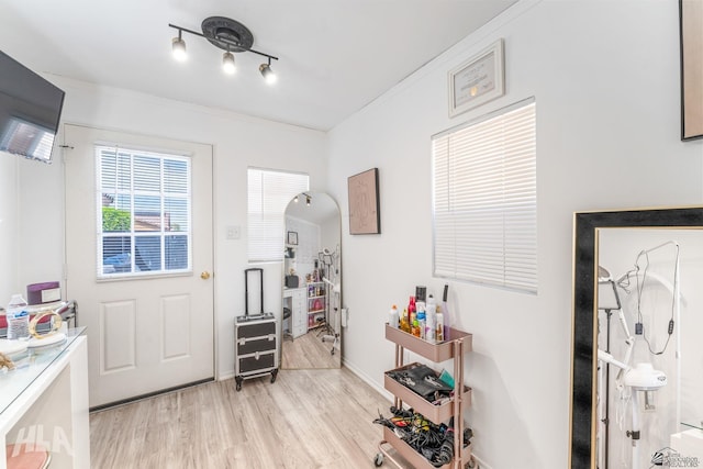 interior space with ornamental molding and light wood-style flooring