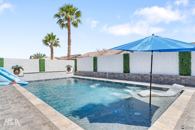 view of swimming pool with a fenced in pool, a fenced backyard, and a patio area