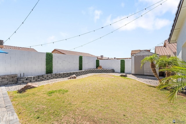 view of yard with a storage shed, an outdoor structure, and a fenced backyard