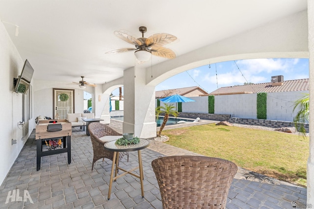 view of patio featuring a fenced in pool, a ceiling fan, outdoor lounge area, and a fenced backyard
