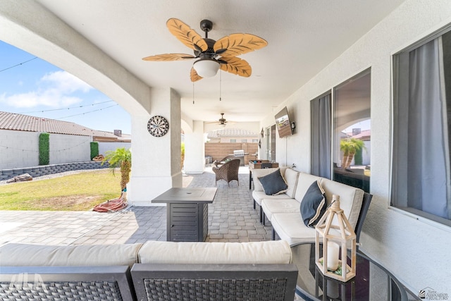 view of patio / terrace with a fenced backyard, ceiling fan, and outdoor lounge area