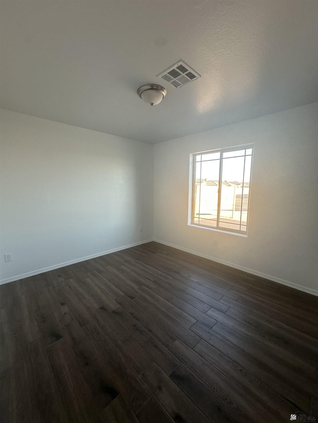 10864 E 45th St, Yuma, AZ 85367 - spare room featuring dark wood-style floors and baseboards