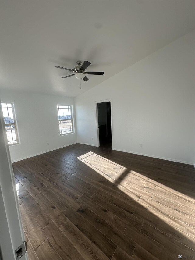 10864 E 45th St, Yuma, AZ 85367 - spare room with dark wood-style flooring, vaulted ceiling, a ceiling fan, and baseboards