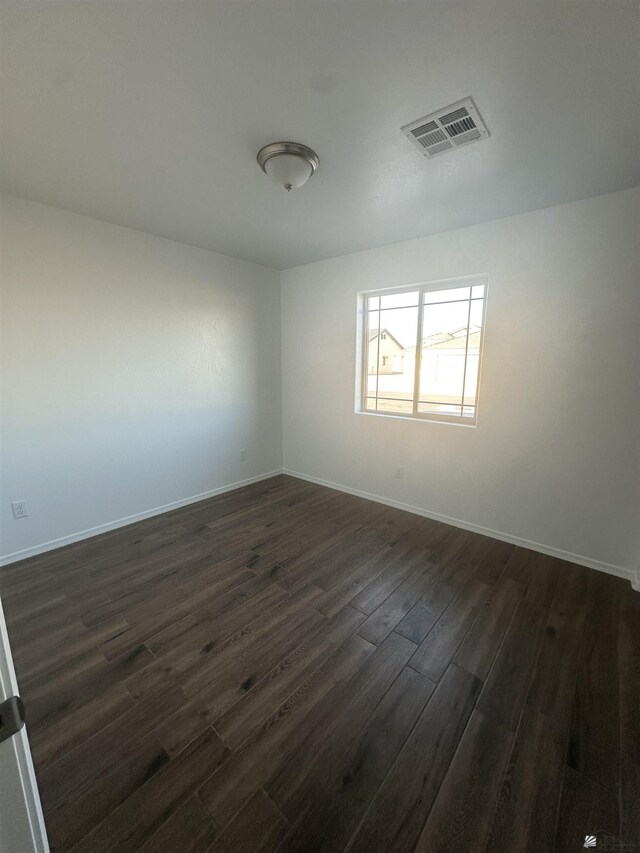 10864 E 45th St, Yuma, AZ 85367 - empty room featuring dark wood-type flooring and baseboards