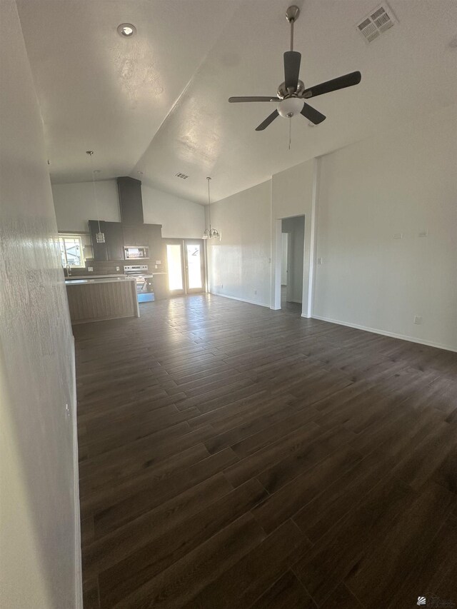 10864 E 45th St, Yuma, AZ 85367 - unfurnished living room featuring vaulted ceiling, dark wood finished floors, ceiling fan, and baseboards