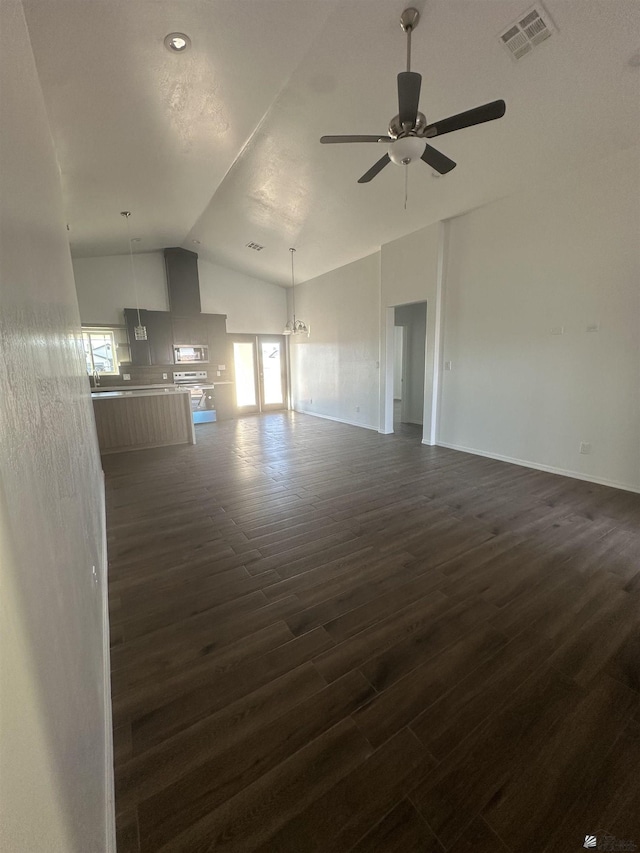10864 E 45th St, Yuma, AZ 85367 - unfurnished living room featuring vaulted ceiling, dark wood finished floors, ceiling fan, and baseboards