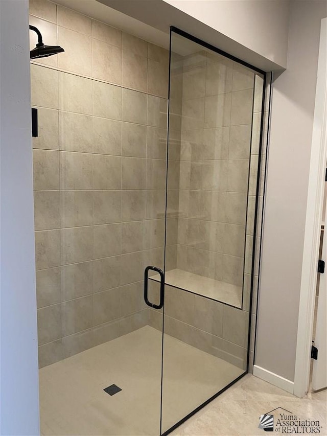 bathroom with tile patterned flooring and a shower with shower door