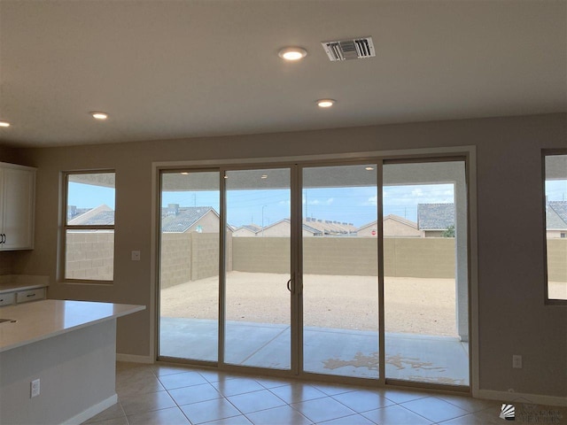 doorway to outside featuring light tile patterned floors and plenty of natural light