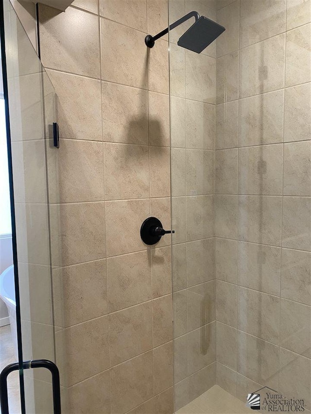 bathroom featuring a shower with shower door