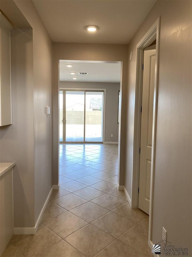 hall featuring light tile patterned flooring