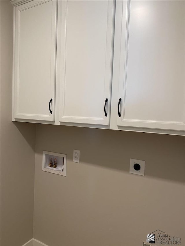 clothes washing area featuring hookup for a washing machine, cabinets, and hookup for an electric dryer