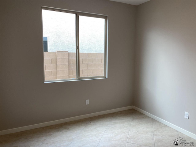 spare room featuring light tile patterned floors