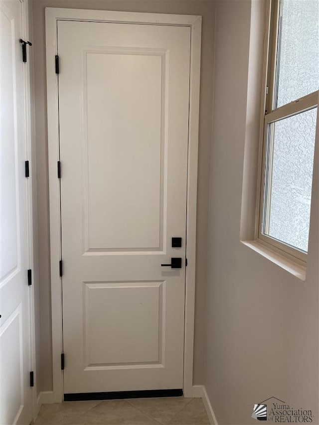 doorway to outside featuring light tile patterned floors