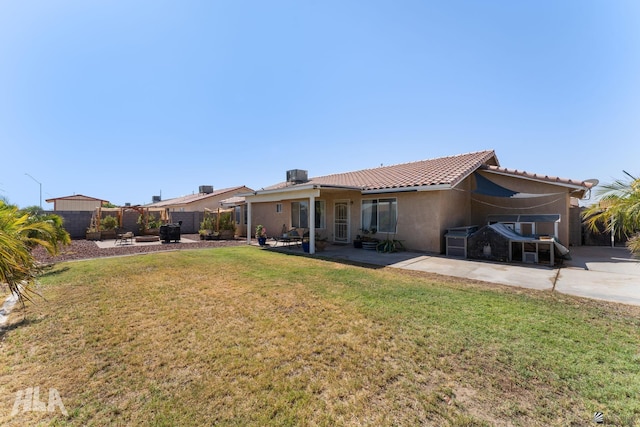 6248 E 42nd Ln, Yuma, AZ 85365 - back of property with a fenced backyard, a patio, stucco siding, and a tile roof