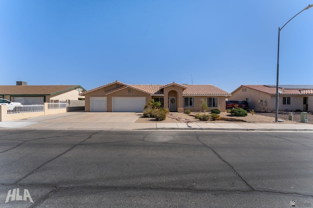 6248 E 42nd Ln, Yuma, AZ 85365 - mediterranean / spanish-style home with a garage, concrete driveway, stucco siding, and a tiled roof