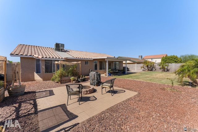 6248 E 42nd Ln, Yuma, AZ 85365 - back of property featuring stucco siding, an outdoor fire pit, a patio, a tile roof, and a fenced backyard