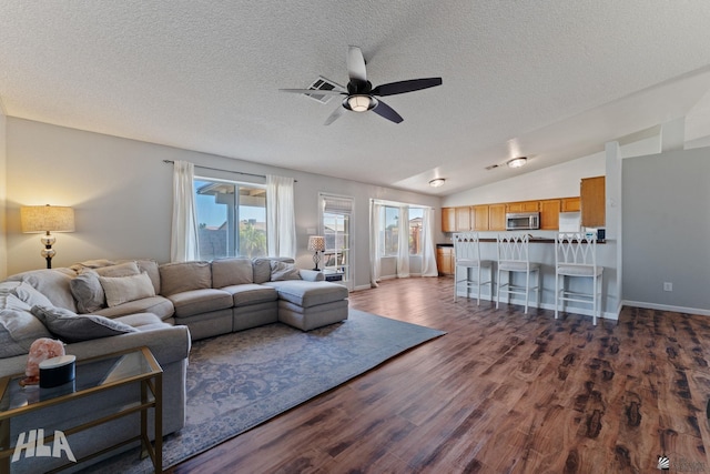 6248 E 42nd Ln, Yuma, AZ 85365 - living area with ceiling fan, a textured ceiling, dark wood-style flooring, and vaulted ceiling