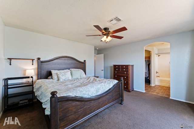 6248 E 42nd Ln, Yuma, AZ 85365 - carpeted bedroom featuring arched walkways, ceiling fan, and a walk in closet