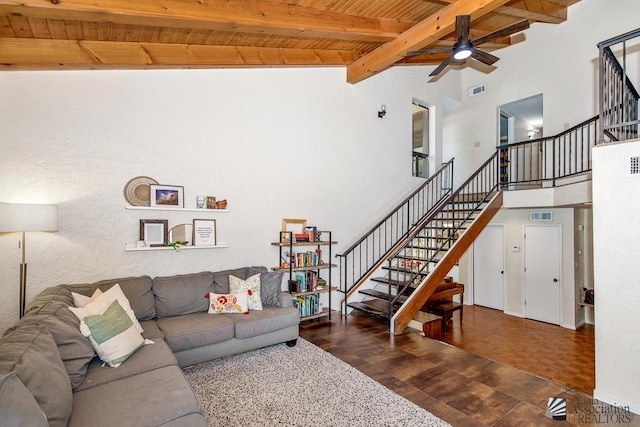 living room featuring ceiling fan, beam ceiling, stairs, wooden ceiling, and wood finished floors