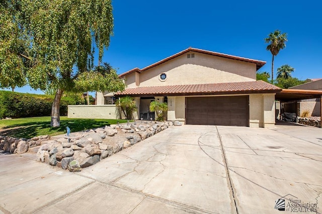 mediterranean / spanish-style home featuring stucco siding, driveway, a front yard, and a garage