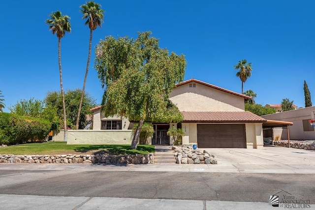 view of front of home featuring a tiled roof, an attached garage, concrete driveway, and stucco siding