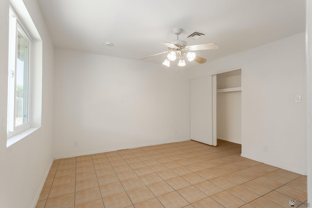 1086 S Arena Dr, Yuma, AZ 85364 - unfurnished bedroom with a closet, ceiling fan, and light tile patterned floors