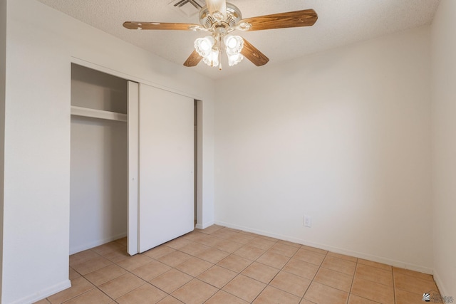 1086 S Arena Dr, Yuma, AZ 85364 - unfurnished bedroom with light tile patterned floors, a closet, and a ceiling fan