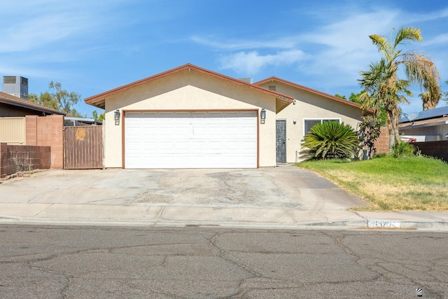 1086 S Arena Dr, Yuma, AZ 85364 - ranch-style home with stucco siding, a gate, concrete driveway, and an attached garage