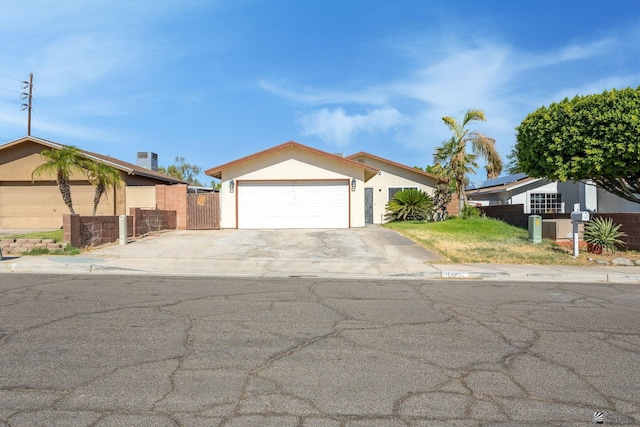 1086 S Arena Dr, Yuma, AZ 85364 - ranch-style home featuring stucco siding, concrete driveway, an attached garage, and a gate