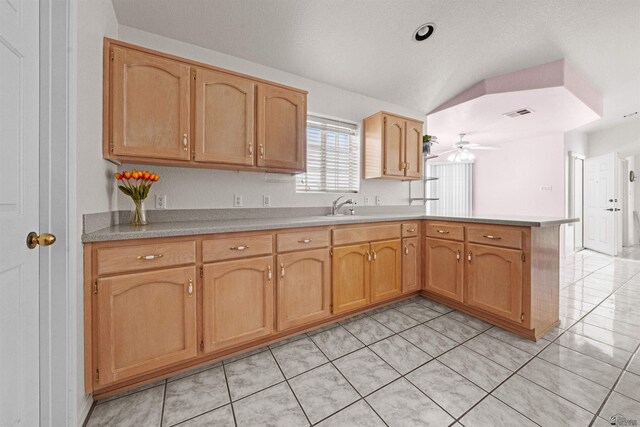 11595 S Prescott Ave, Yuma, AZ 85365 - kitchen featuring a peninsula, light countertops, vaulted ceiling, ceiling fan, and light tile patterned floors