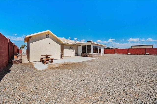 11595 S Prescott Ave, Yuma, AZ 85365 - back of house featuring a patio, a fenced backyard, and a sunroom