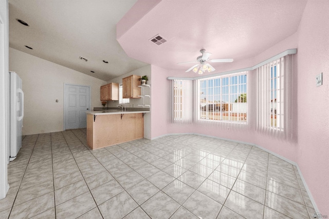 11595 S Prescott Ave, Yuma, AZ 85365 - kitchen with a ceiling fan, open floor plan, light tile patterned flooring, lofted ceiling, and a kitchen bar