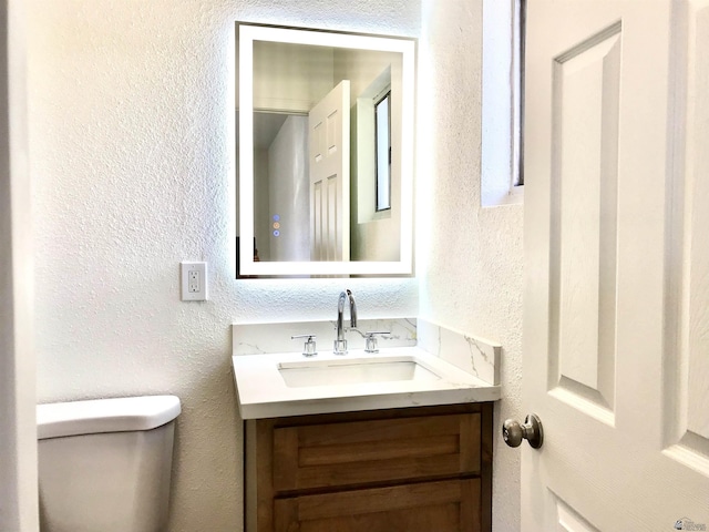 275 E 26th St, Yuma, AZ 85364 - half bath featuring vanity, a textured wall, and toilet