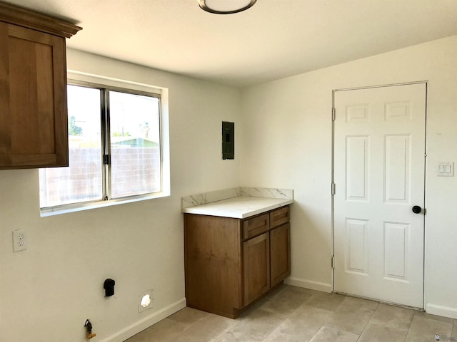 275 E 26th St, Yuma, AZ 85364 - clothes washing area featuring baseboards, light tile patterned floors, and electric panel