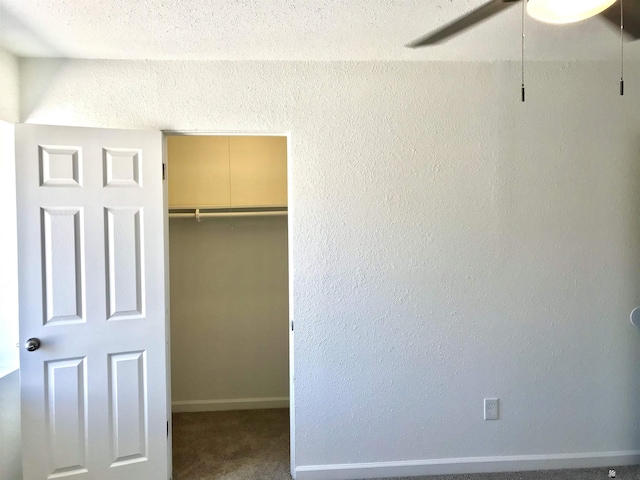275 E 26th St, Yuma, AZ 85364 - unfurnished bedroom featuring a textured wall, a walk in closet, carpet, baseboards, and a closet