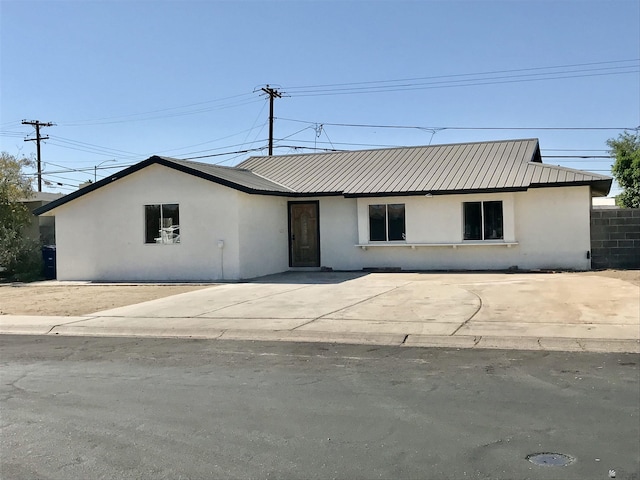 275 E 26th St, Yuma, AZ 85364 - ranch-style house with stucco siding and metal roof
