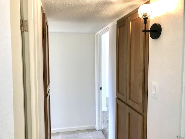 275 E 26th St, Yuma, AZ 85364 - hall with baseboards, light tile patterned flooring, and a textured ceiling