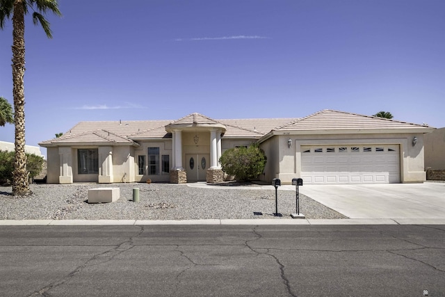14158 E 49th Dr, Yuma, AZ 85367 - view of front of house with stucco siding, a tiled roof, concrete driveway, and a garage