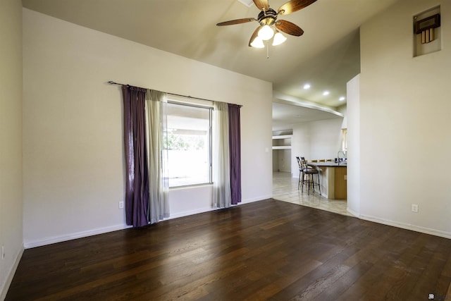 14158 E 49th Dr, Yuma, AZ 85367 - unfurnished living room featuring a ceiling fan, baseboards, recessed lighting, wood finished floors, and lofted ceiling