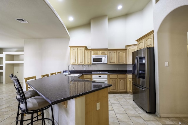 14158 E 49th Dr, Yuma, AZ 85367 - kitchen with visible vents, a sink, arched walkways, and white appliances
