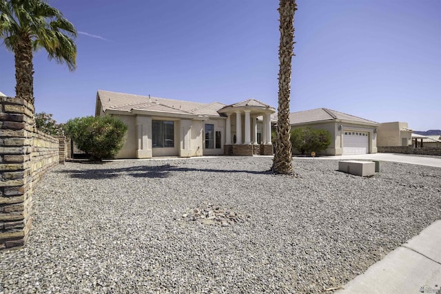 14158 E 49th Dr, Yuma, AZ 85367 - view of front of house featuring a garage, fence, stucco siding, a tiled roof, and driveway