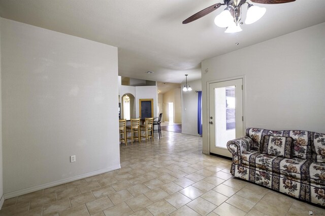 14158 E 49th Dr, Yuma, AZ 85367 - living room featuring baseboards, arched walkways, and ceiling fan