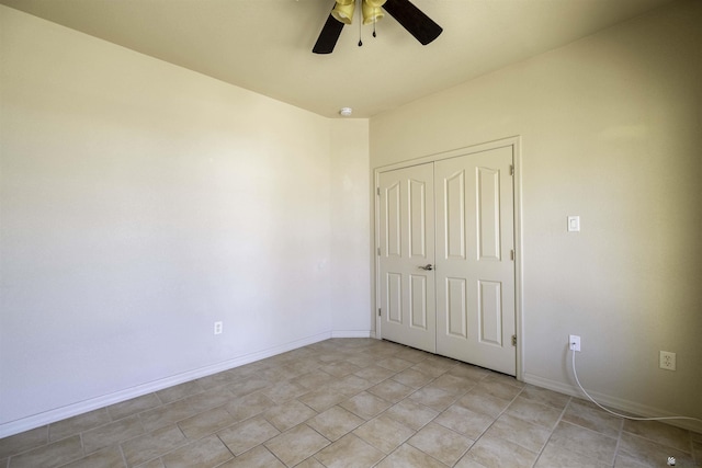 14158 E 49th Dr, Yuma, AZ 85367 - unfurnished bedroom with light tile patterned floors, baseboards, a ceiling fan, and a closet